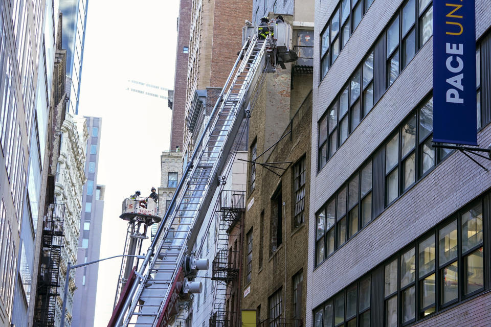 Firefighters work at the scene of a partial collapse of a parking garage in the Financial District of New York, Tuesday, April 18, 2023. (AP Photo/Mary Altaffer)