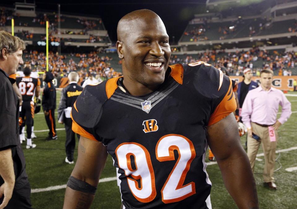 FILE - In this Sept. 17, 2013, file photo, Cincinnati Bengals outside linebacker James Harrison leaves the field following a win over the Pittsburgh Steelers in an NFL football game in Cincinnati. Harrison, the 2008 Defensive Player of the Year was cut by Cincinnati, where he spent only the 2013 season after being released by Pittsburgh. (AP Photo/David Kohl, File)
