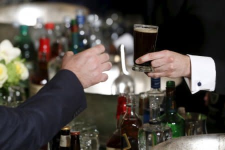 FILE PHOTO: A waiter delivers a glass of Guinness during a St. Patrick's Day reception at the White House in Washington March 15, 2016. REUTERS/Jonathan Ernst