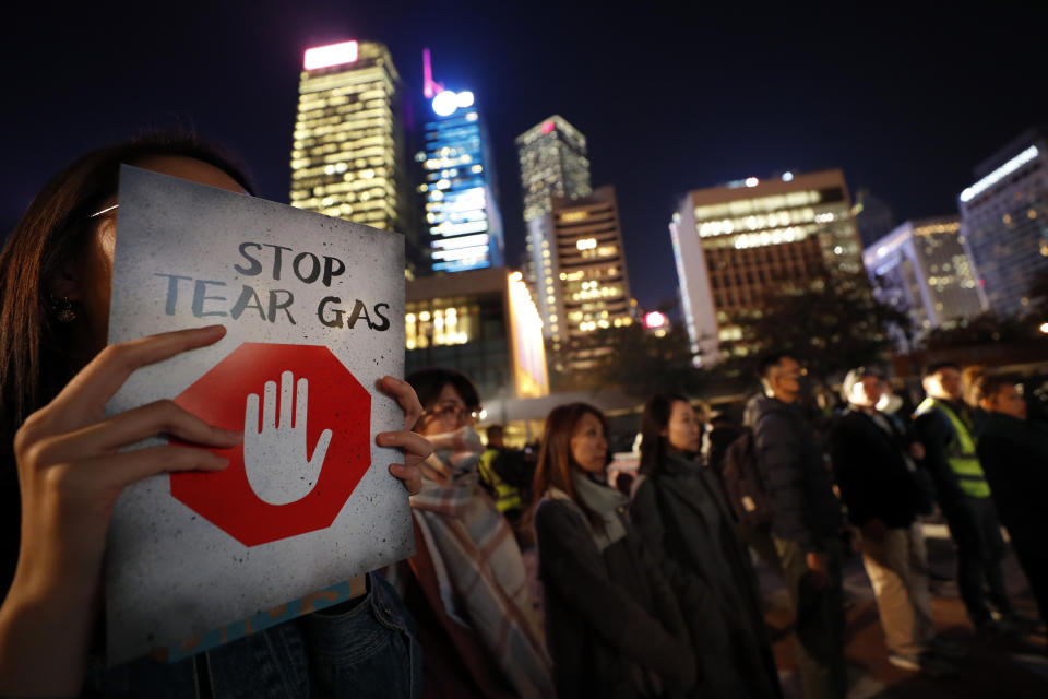 A protester holds a sign reading "Stop Tear Gas" during a rally against the police's use of tear gas in Hong Kong, Friday, Dec. 6, 2019. Hong Kong police have fired more than 10,000 tear gas canisters to quell violent protests that have rocked the city for six months. Its heavy and prolonged use in Hong Kong — one of the world's most densely populated cities and known for its concrete jungle of high-rises — is unusual and has sparked health fears. (AP Photo/Vincent Thian)