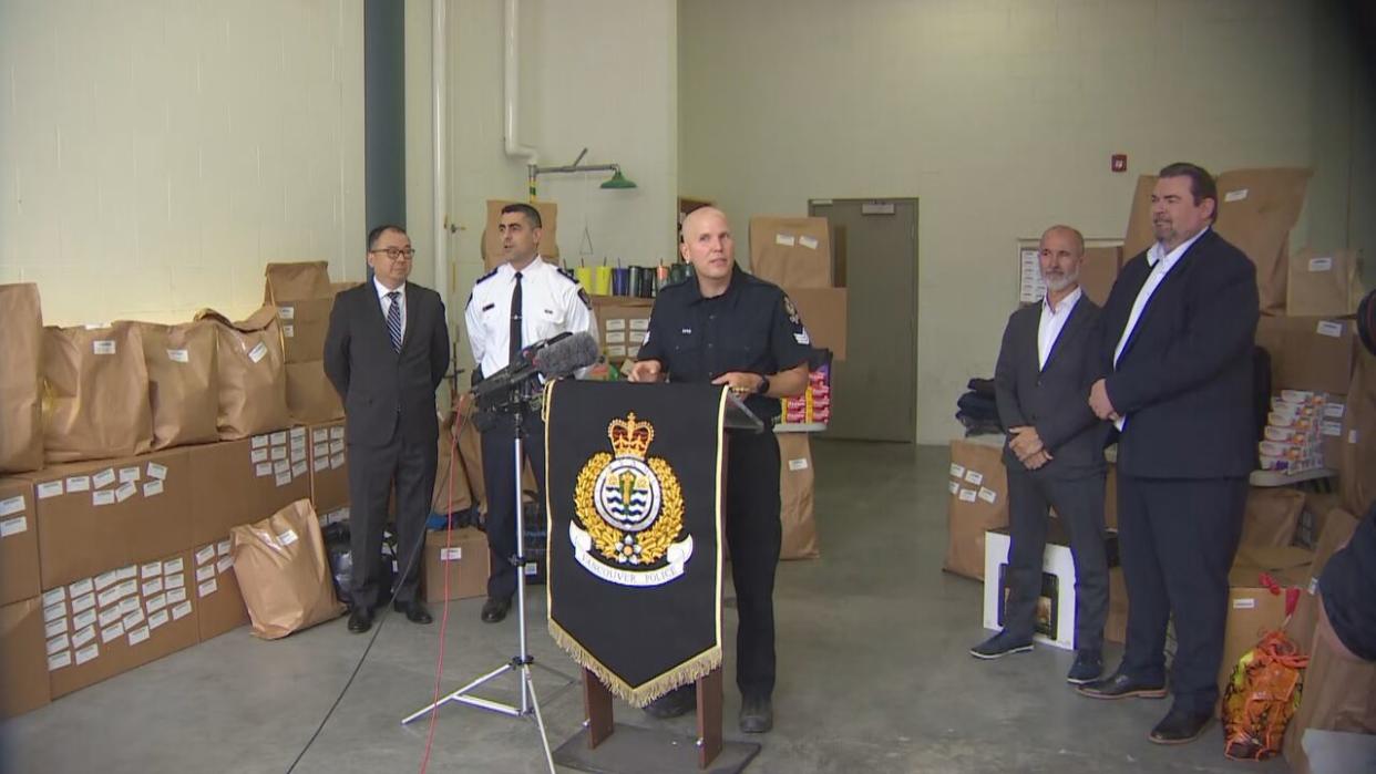 VPD Sgt. Steve Addision speaks to media in front of a display of stolen goods. (Maggie McPherson/CBC - image credit)