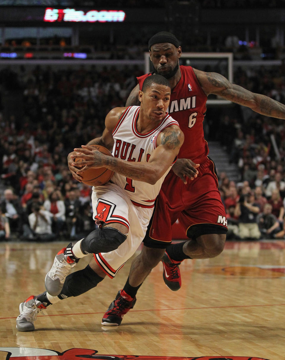 CHICAGO, IL - APRIL 12: Derrick Rose #1 of the Chicago Bulls drives past LeBron James #6 of the Miami Heat at the United Center on April 12, 2012 in Chicago, Illinois. The Bulls defeated the Heat 96-86 in overtime. NOTE TO USER: User expressly acknowledges and agrees that, by downloading and or using this photograph, User is consenting to the terms and conditions of the Getty Images License Agreement. (Photo by Jonathan Daniel/Getty Images)