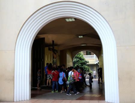 Filipino Catholic devotees touch the statue of crucified Jesus Christ after attending a mass at a National Shrine of Our Mother of Perpetual Help in Baclaran, Paranaque city, metro Manila, Philippines September 18, 2016. REUTERS/Romeo Ranoco/File Photo