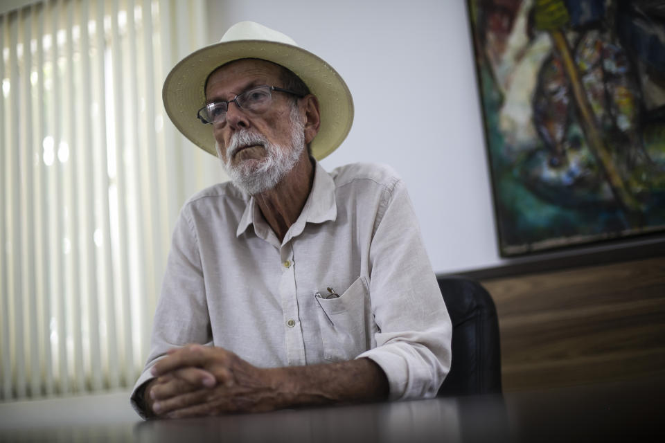 Mayor Jose Bonifacio listens during an interview in his City Hall office of Cabo Frio, Brazil, Wednesday, Dec. 15, 2021. Bonifacio acknowledges his city found itself under a spell. “The talk of the town was to know how much [bitcoin] was at, who was giving a bigger return,” he said. (AP Photo/Bruna Prado)