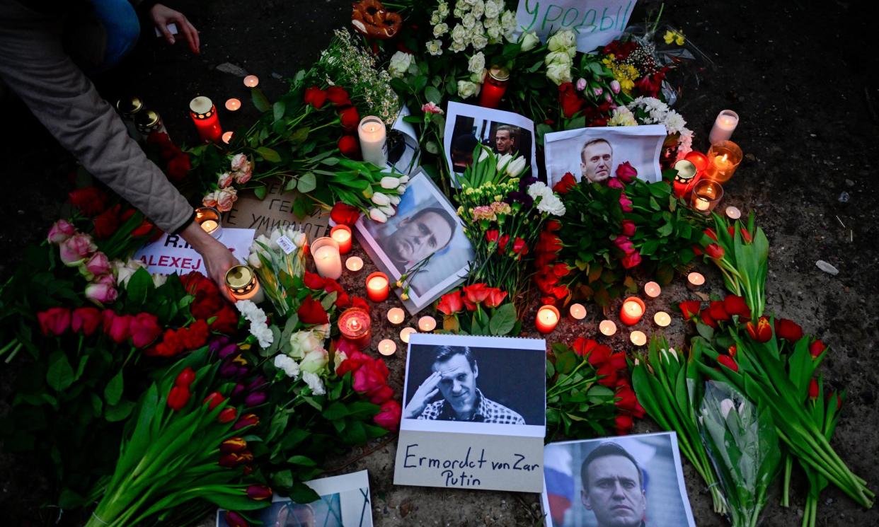 <span>Flowers, candles and photos of Alexei Navalny left in front of the Russian embassy in Berlin after news of his death in February. </span><span>Photograph: John MacDougall/AFP/Getty Images</span>