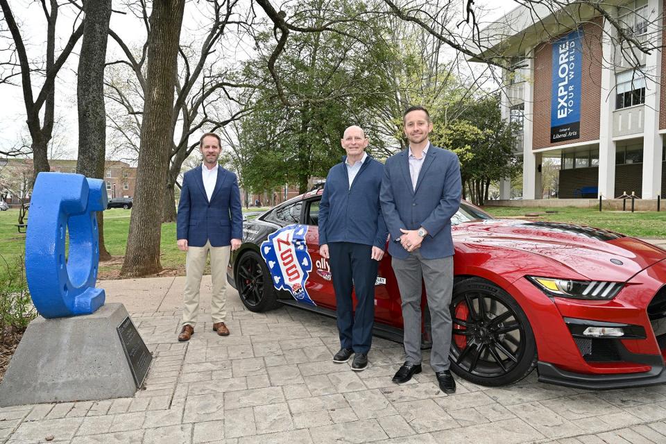 Nashville Superspeedway General Manager Matt Greci, right, and Jonathan Thomas, left, the speedway’s vice president for corporate sales, brought the Ally 400 Pace Car to campus during their recent meeting with retired Army Lt. Gen. Keith Huber, center, MTSU’s senior adviser for veterans and leadership initiatives.