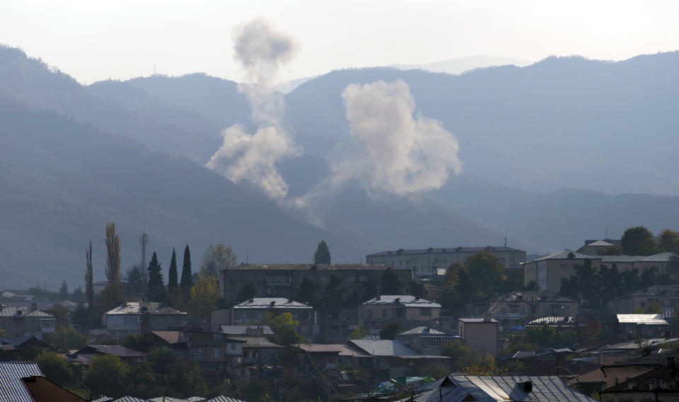 Smoke rises after shelling by Azerbaijan's artillery during a military conflict outside Stepanakert, the separatist region of Nagorno-Karabakh, Thursday, Oct. 29, 2020. Fighting over the separatist territory of Nagorno-Karabakh continued on Thursday, as the latest cease-fire agreement brokered by the U.S. failed to halt the flare-up of a decades-old conflict between Armenia and Azerbaijan. (AP Photo)