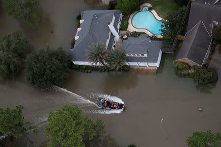 Residents are evacuated through flood waters caused by Tropical Storm Harvey in West Houston, Texas, U.S. August 30, 2017. REUTERS/Adrees Latif