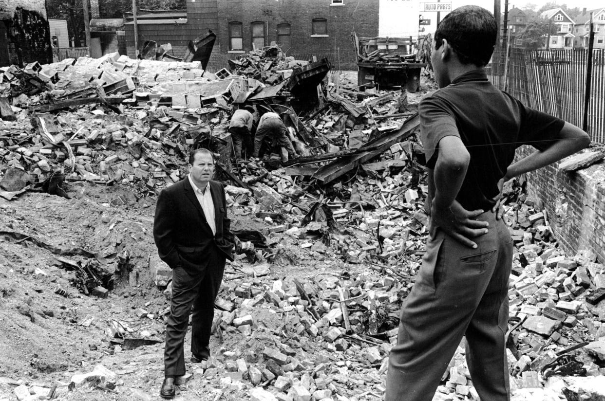 Former Detroit Mayor Jerome Cavanagh speaks to a young man on Detroit 's east side amid rubble in the aftermath of the 1967 riot.