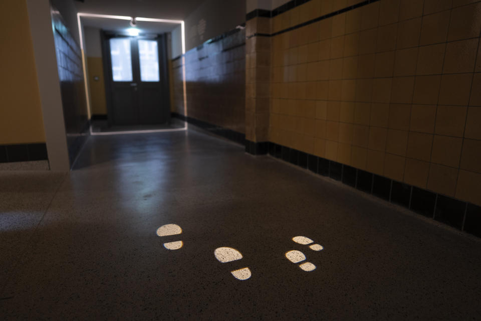 Illuminated footsteps show the escape route used to spirit some 600 children to safety during World War II Nazi occupation, at the new National Holocaust Museum in Amsterdam, Netherlands, Tuesday, March 5, 2024. (AP Photo/Peter Dejong)