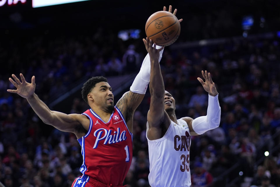 Cleveland Cavaliers' Isaac Okoro, right, goes up for a shot against Philadelphia 76ers' KJ Martin during the first half of an NBA basketball game, Friday, Feb. 23, 2024, in Philadelphia. (AP Photo/Matt Slocum)