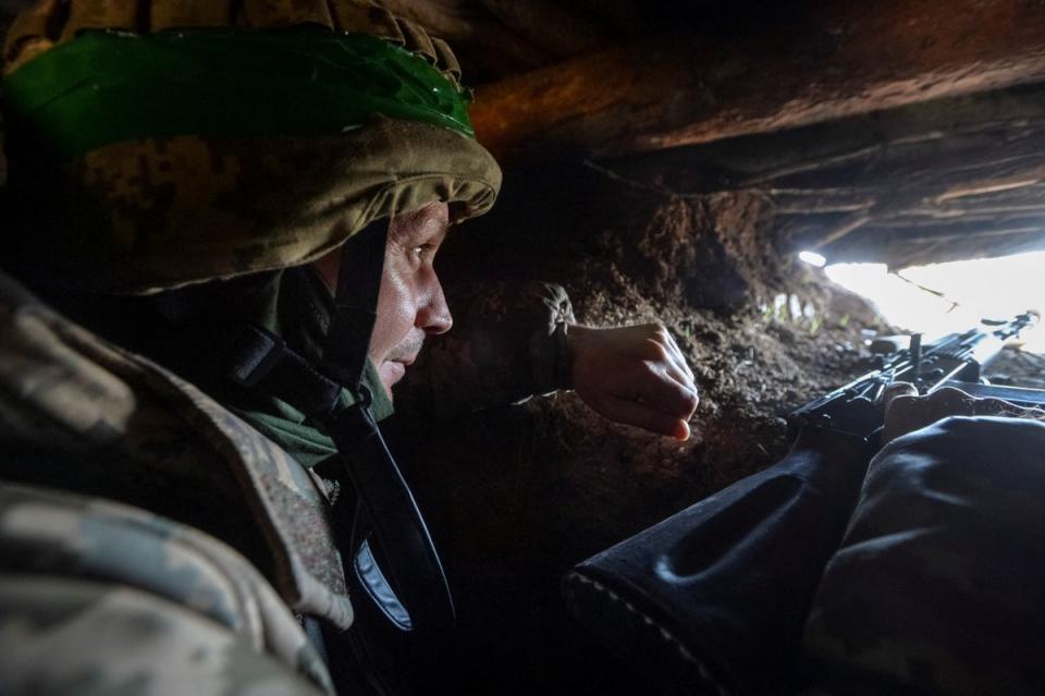 A Ukrainian service member is seen in a trench at a position on a front line, as Russia’s attack on Ukraine continues, near the city of Bakhmut, Ukraine 10 April 2023 (REUTERS)