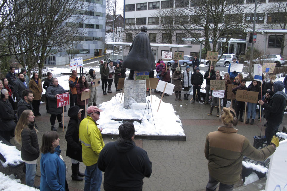 People rally in support of renewable energy policies, such as strengthening a renewable energy fund, across from the Alaska Capitol on Friday, Feb. 3, 2023, in Juneau, Alaska. Some environmentalists are skeptical of legislation proposed by Gov. Mike Dunleavy that aims to capitalize on carbon storage and carbon markets. (AP Photo/Becky Bohrer)