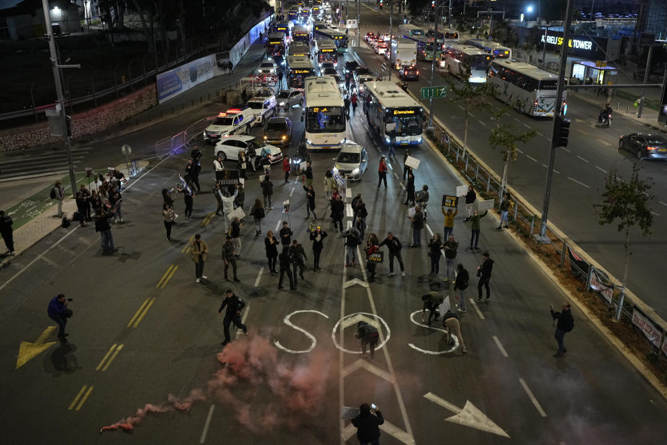 People block a street during a protest calling for a deal to release the hostages held in the Gaza Strip by the Hamas militant group, in Tel Aviv, Israel, Thursday, Feb. 29, 2024. (AP Photo/Ohad Zwigenberg)