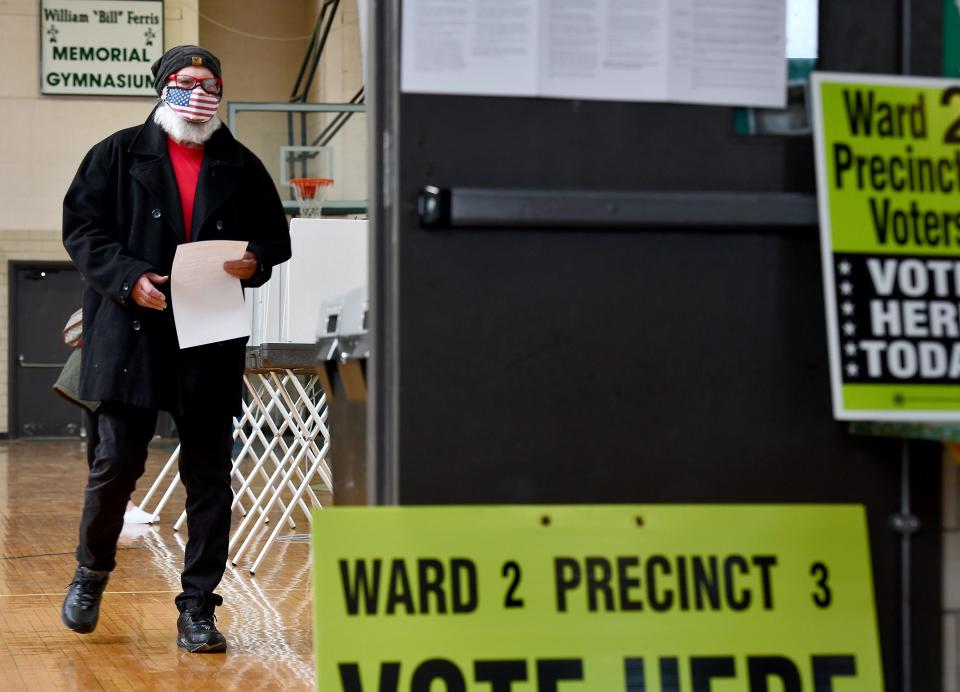 Gail Alexander takes his ballot to the box at Burncoat High School Tuesday morning.