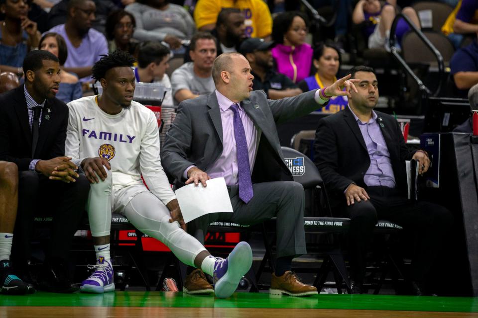 LSU assistant coach Bill Armstrong, center, coaches from the bench during the first half of the first round men's college basketball game against Yale in the NCAA Tournament, in Jacksonville, Fla. Thursday, March 21, 2019.