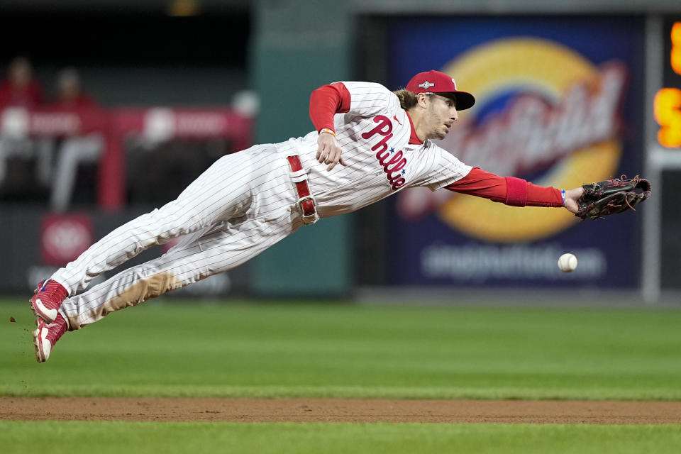 Philadelphia Phillies second baseman Bryson Stott misses a throw to second during the seventh inning in Game 1 of the baseball NL Championship Series Arizona Diamondbacks in Philadelphia, Monday, Oct. 16, 2023. (AP Photo/Brynn Anderson)