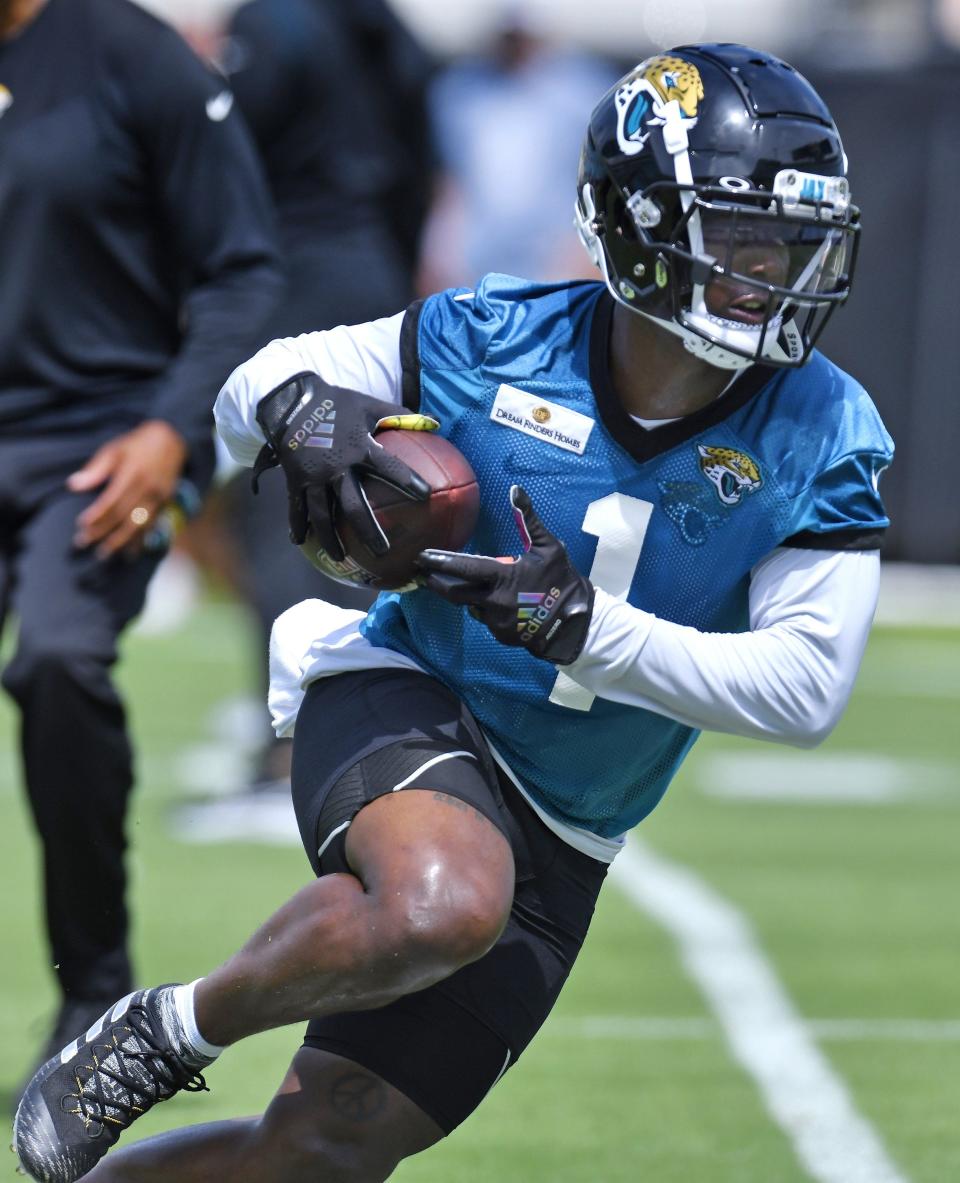 Jaguars RB (1) Travis Etienne Jr. runs with the ball during passing drills at the Jacksonville Jaguars Organized Team Activity session at TIAA Bank Field Monday, May 23, 2022. [Bob Self/Florida Times-Union]