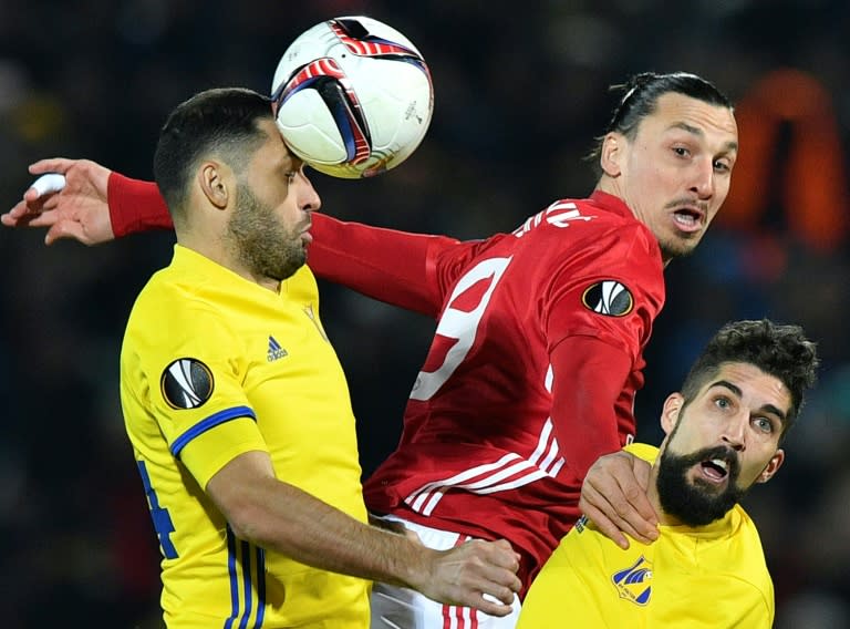 Manchester United's Zlatan Ibrahimovic (C) fights for the ball with Rostov's Aleksandr Gatskan (L) and Miha Mevlja during their UEFA Europa League round of 16 1st leg match, at Olimp-2 Arena in Rostov-on-Don, on March 9, 2017