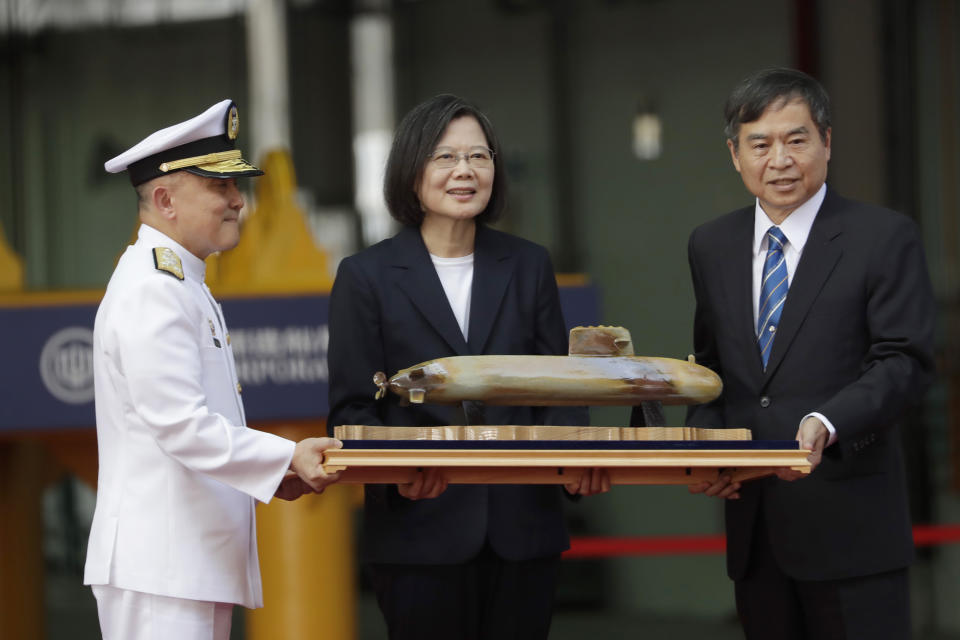 Taiwan's President Tsai Ing-wen, center, poses with the model of submarine prototype during the naming and launching ceremony of domestically-made submarines at CSBC Corp's shipyards in Kaohsiung, southern Taiwan, Thursday, Sept. 28, 2023. Tsai launched the island's first domestically made submarine for testing Thursday. (AP Photo/Chiang Ying-ying)