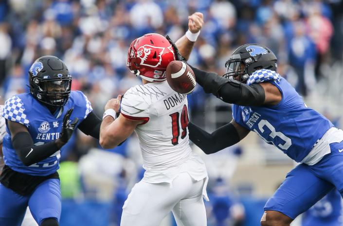 Louisville's Brock Domann gets hammered by Kentucky linebacker J.J. Weaver for a fumble and Wildcat recovery in the first half in Saturday's Governors Cup college football game. Nov. 26, 2022.  