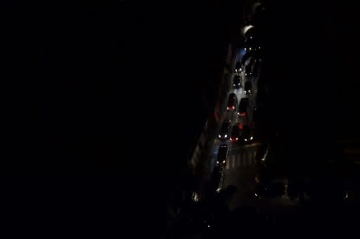 Drivers try to move along a pitch-dark, congested street during a new power outage in Caracas on March 29, 2019