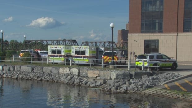 Emergency crews were on Lemieux Island near the Prince of Wales Bridge on June 20, 2021, after a swimmer jumped off the bridge into the Ottawa River and failed to resurface. His body was recovered late Sunday night, Ottawa police confirmed.  (Radio-Canada - image credit)