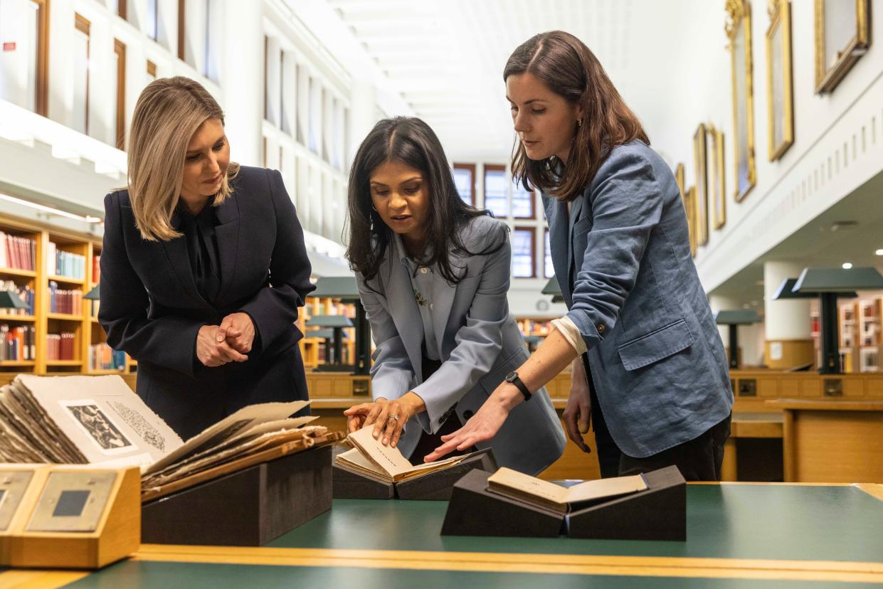 Akshata Murty and Olena Zelenska look at the Ukrainian collection as they visit The British Library in central London (AP)