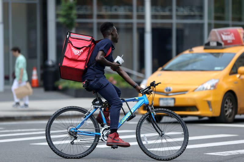 FILE PHOTO: Delivery man cycles in New York