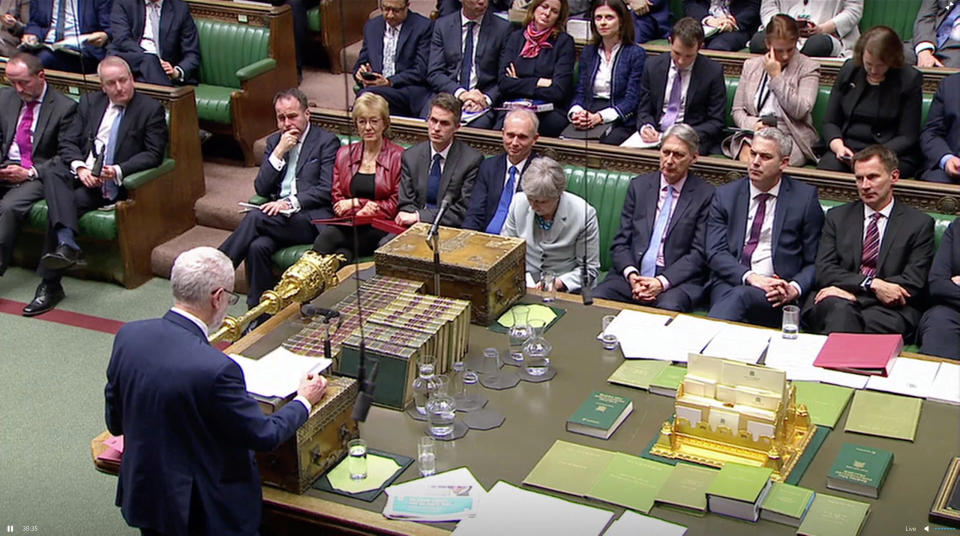 ‘National embarrassment’: Theresa May listens to Labour Party leader Jeremy Corbyn in the Commons. (REUTERS)