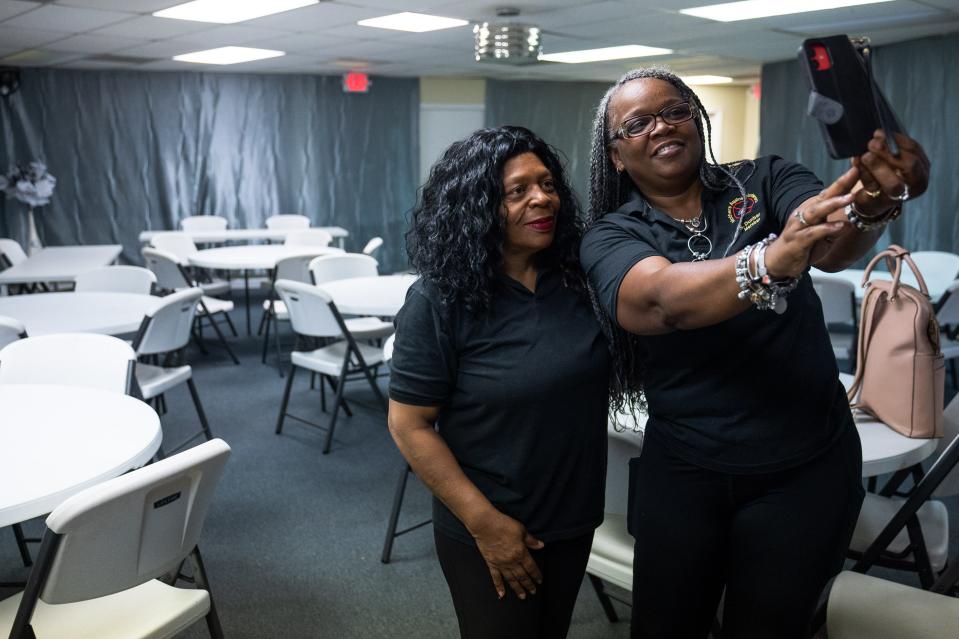 Mothers Against Murders Association founder Angela Williams takes a selfie with M.A.M.A member Sharon Danford, of Riviera Beach, at the Mothers Against Murders Association office in West Palm Beach.