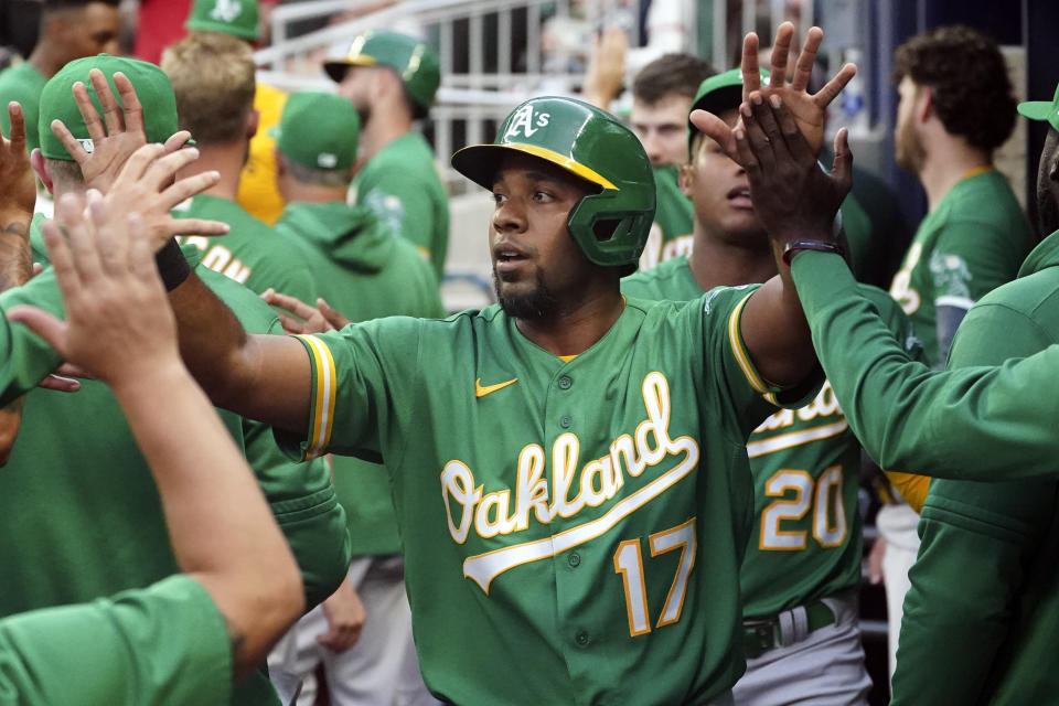 Oakland Athletics' Elvis Andrus (17) after scoring on a hit by Ramon Laureano in the first inning of the team's baseball game against the Atlanta Braves Tuesday, June 7, 2022, in Atlanta. (AP Photo/John Bazemore)