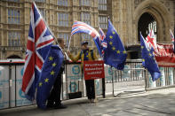 Anti-Brexit remain in the European Union supporters protest across the street from the Houses of Parliament in London, Tuesday, Oct. 15, 2019. A Brexit divorce deal is still possible ahead of Thursday's European Union summit but the British government needs to move ahead with more compromises to seal an agreement in the next few hours, the bloc said Tuesday. (AP Photo/Matt Dunham)