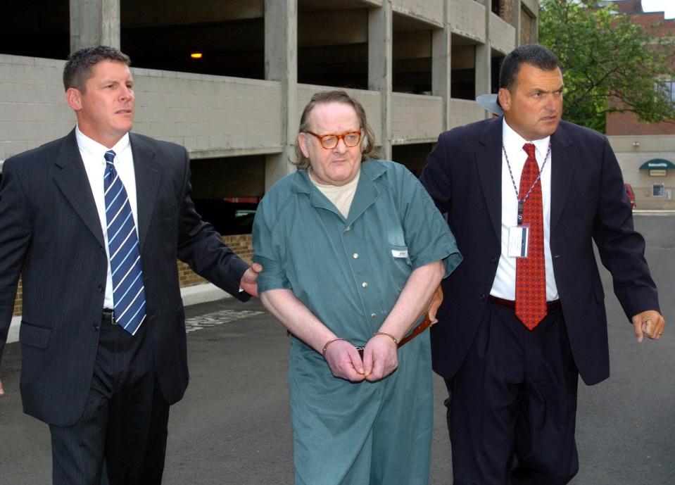 Kenneth E. Barnes, center, is led to the Erie FBI office in July 2007 to be processed before his first federal court appearance in the death of Erie pizza deliveryman Brian Wells on Aug, 28, 2003. Escorting him are, at left, Jason Wick, with the federal Bureau of Alcohol, Tobacco, Firearms and Explosives, and FBI Special Agent Jerry Clark. Barnes died in federal prison at 65 in 2019. Wick and Clark are retired from law enforcement and were the lead investigators on the pizza bomber case.
