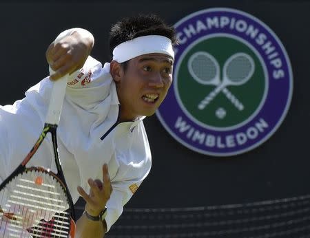 Kei Nishikori of Japan serves during his match against Simone Bolelli of Italy at the Wimbledon Tennis Championships in London, June 29, 2015. REUTERS/Toby Melville