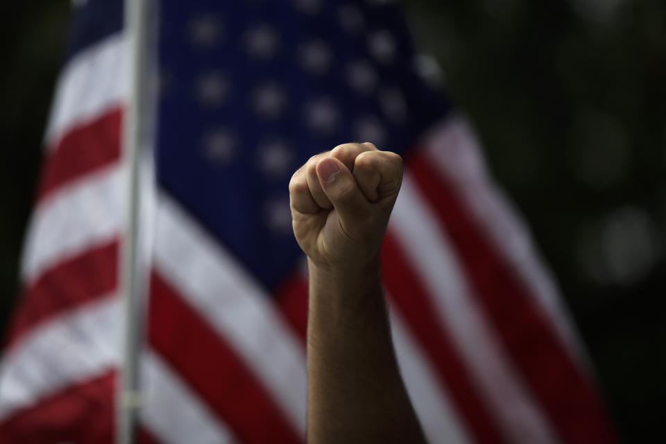 A demonstrator raises his fist during a protest over the death of George Floyd, in Anaheim, Calif., June 1, 2020. (AP Photo/Jae C. Hong)