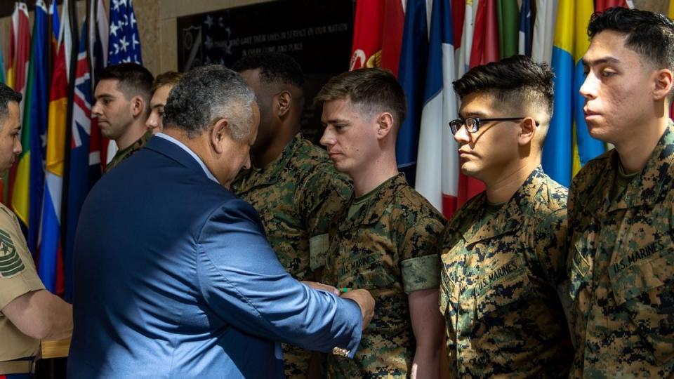 Secretary of the Navy Carlos Del Toro presents the Navy and Marine Corps Achievement Medal to Marine Security Guards in Quantico, Virginia, May 19. (Sgt. Braden Hale/Marine Corps)