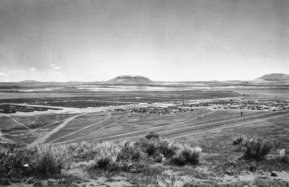 FILE - In this Nov. 5, 1943, file photo, a general view of Tule Lake, California Japanese Internment Camp, is seen. As the 75th anniversary of the formal Sept. 2 surrender ceremony that ended WWII approaches, Hidekazu Tamura, a former Japanese-American living in Santa Maria, California has vivid memories of the wartime years he spent in the United States, torn between two nationalities, and the events that led him to renounce his American citizenship and return to Japan. During the pacific war period, Tamura was at Tule Lake, a segregation center for those deemed disloyal, where he joined a group called “Hokoku Seinen Dan,” which means, “Young Men’s Association to Serve the Fatherland.” (AP Photo, File)