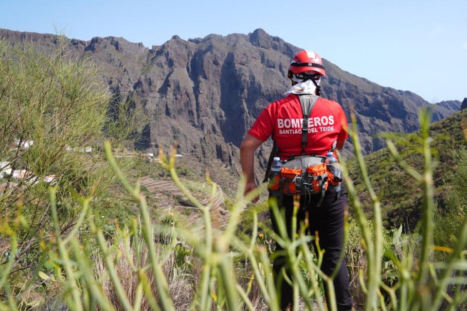 A firefighter looks over the village of Masca, Tenerife, amid searches for Jay Slater (PA Wire)