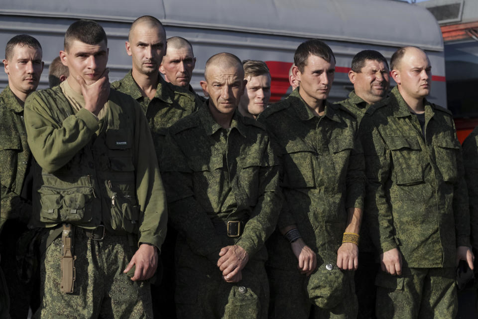 FILE - Russian recruits stand waiting to take a train at a railway station in Prudboi, Volgograd region of Russia, Sept. 29, 2022. Since Russian President Vladimir Putin announced his mobilization on Sept. 21 for the war in Ukraine, independent media, human rights activists and draftees themselves have painted a bleak picture of a haphazard, chaotic and ethnically biased effort to round up as many men as possible and push them quickly to the front, regardless of skill or training. (AP Photo/File)