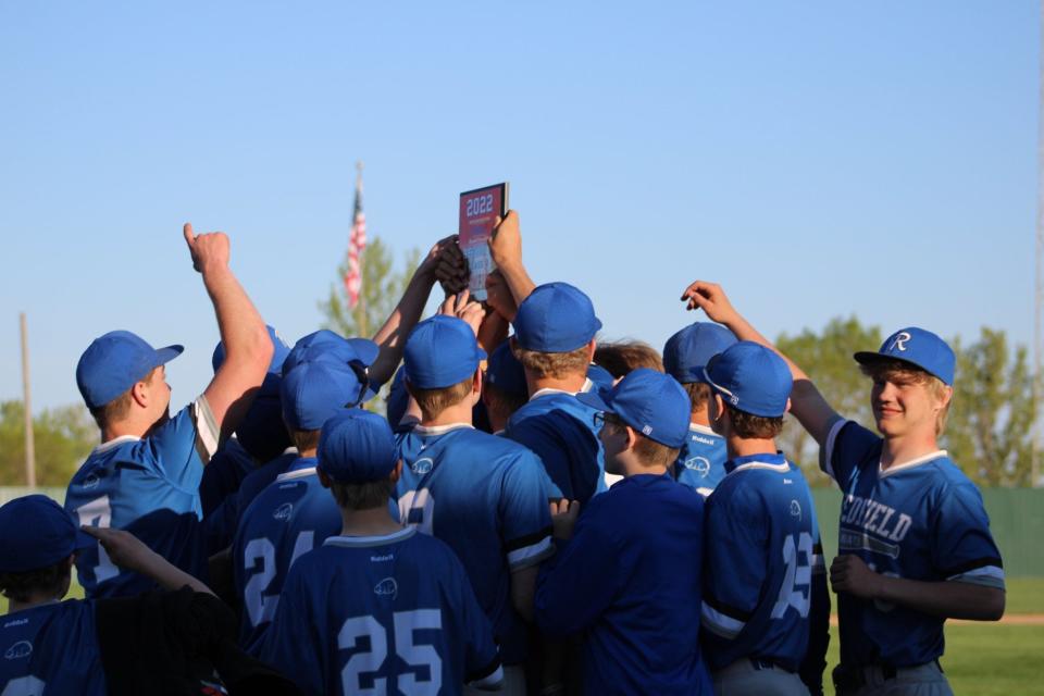 The Redfield Area Muskrats celebrate with the Region 2B championship plaque after downing Howard on May 22.