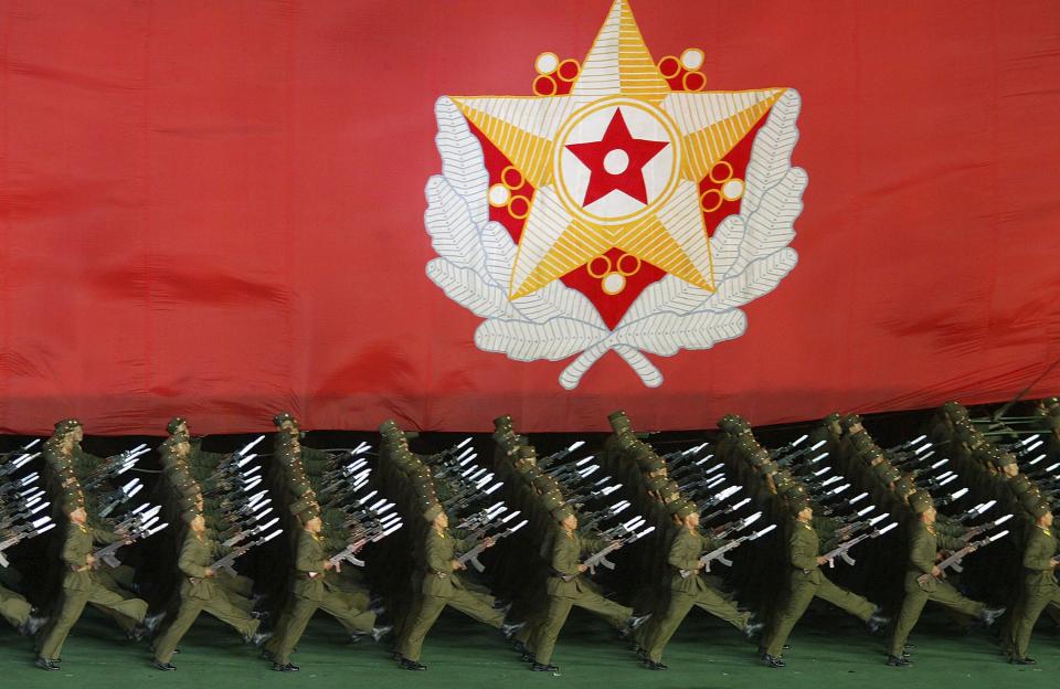 North Korean military cadets hold a North Korean leader Kim Jong-Il's flag during a perform of the Arirang festival which is a part of commemorations marking the 60th anniversary of the Workers' Party of North Korea on October 6, 2005, in Pyongyang, North Korea.