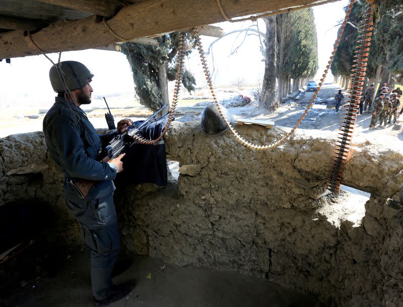 FILE PHOTO: An Afghan security force member stands guard at a security tower where two U.S soldiers were killed a day before in Shirzad district of Nangarhar province