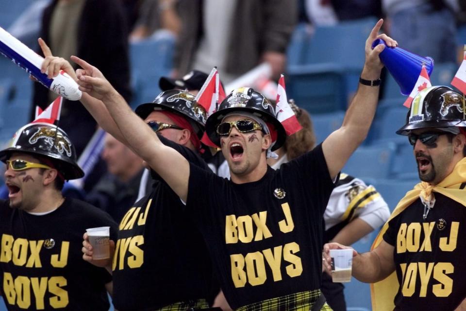 More than 45,000 people, including these Hamilton Tiger-Cat fans, attended the 1999 Grey Cup at Vancouver's B.C. Place. But what they did they watch during halftime?