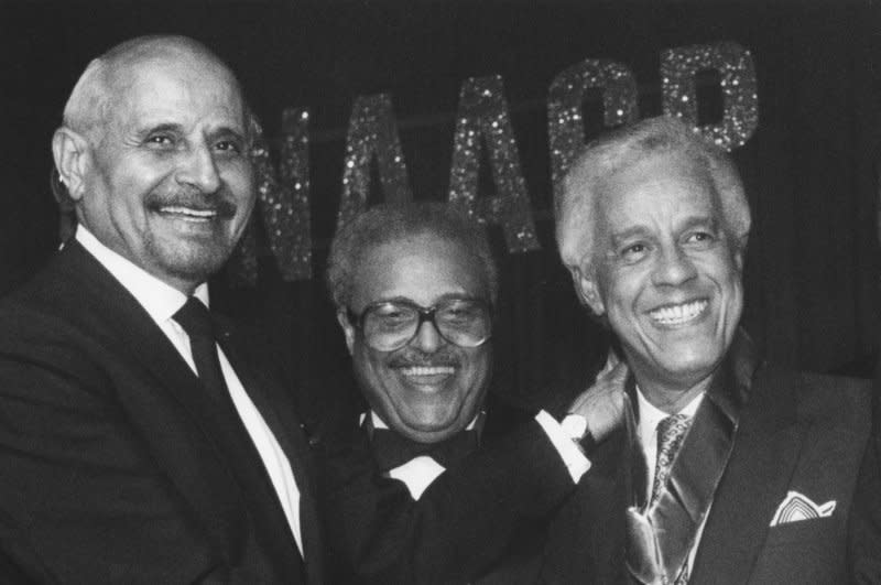 L. Douglas Wilder (R) beams upon receiving the 75th NAACP Spingarn Medal from former recipient Percy Ellis Sutten (L) of New York on July 12, 1990, in Los Angeles. On Jan. 13, 1990, Wilder took office in Virginia, becoming the first elected African-American governor of a U.S. state. File Photo by Jim Ruymen/UPI