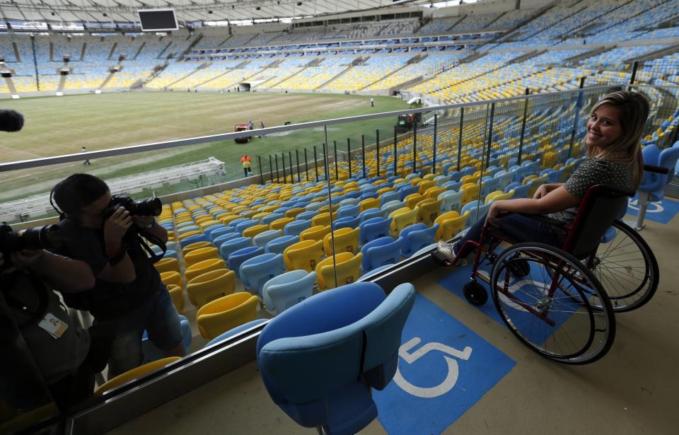 A woman simulates using a wheelchair at a physically handicapped lot inside of the Maracana stadium during a press visit. (Sergio Moraes/Reuters)
