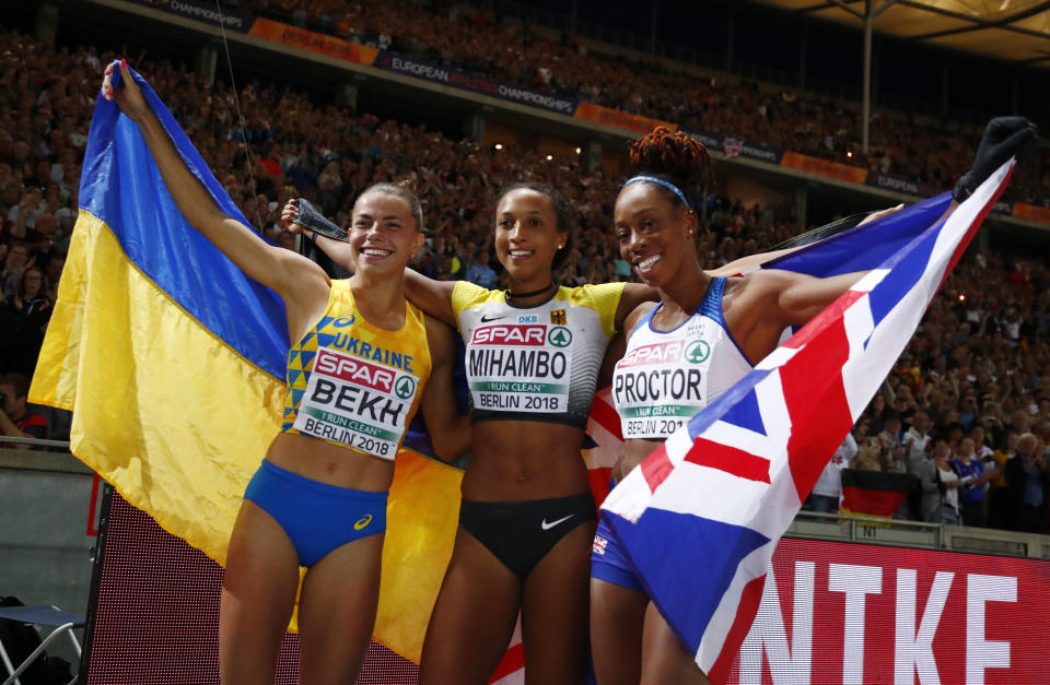 Germany's gold medal winner Malaika Mihambo is flanked by Ukraine's silver medal winner Maryna Bekh, left, and Britain's bronze medal winner Shara Proctor as they celebrate after the women's long jump final at the European Athletics Championships at the Olympic stadium in Berlin, Germany, Saturday, Aug. 11, 2018. (AP Photo/Matthias Schrader)