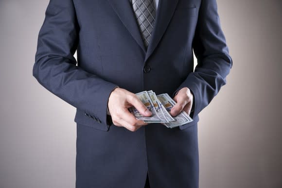 Man in a suit with money in his hands