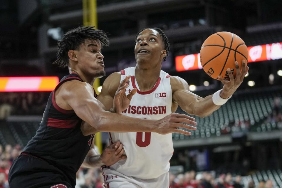 Wisconsin's Jahcobi Neath shoots past Stanford's Spencer Jones during the first half of an NCAA college basketball game Friday, Nov. 11, 2022, in Milwaukee. The game is being played at American Family Field, home of the Milwaukee Brewers. (AP Photo/Morry Gash)