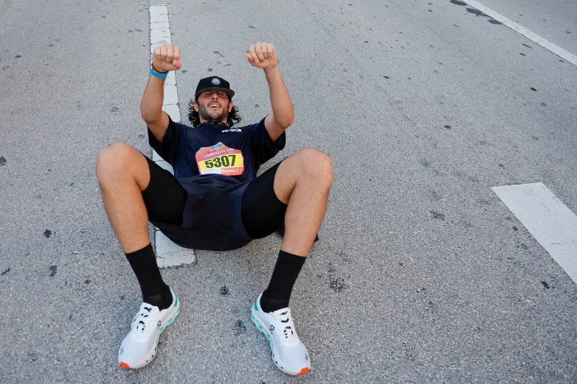 A runner reacts after crossing the finish line during the Miami Lexus Corporate Run in downtown Miami on Thursday, April 27, 2023. SAM NAVARRO/Special for the Miami Herald